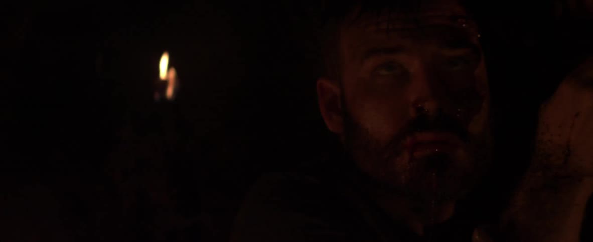 A man is walking in a dark cave