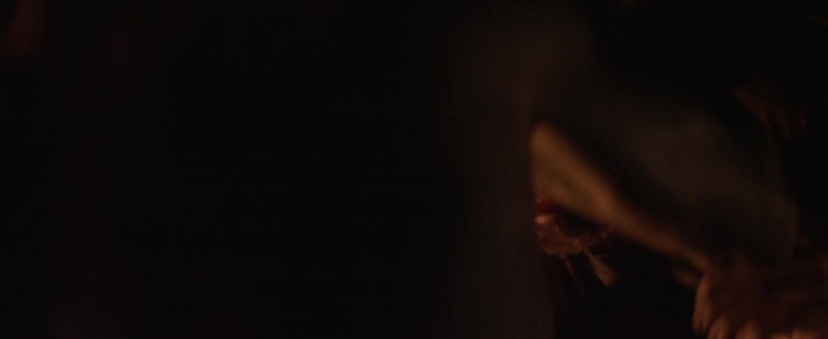 Two men fight in a dark cave