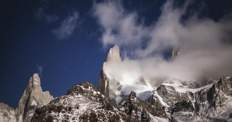 The clouds move fast over the mountain