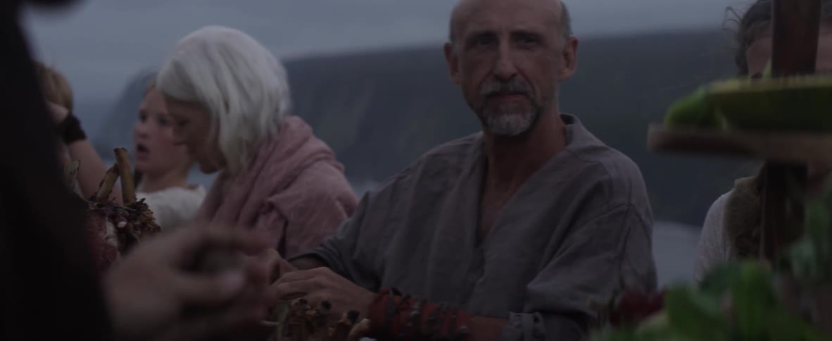 People sit together outside on a cloudy day