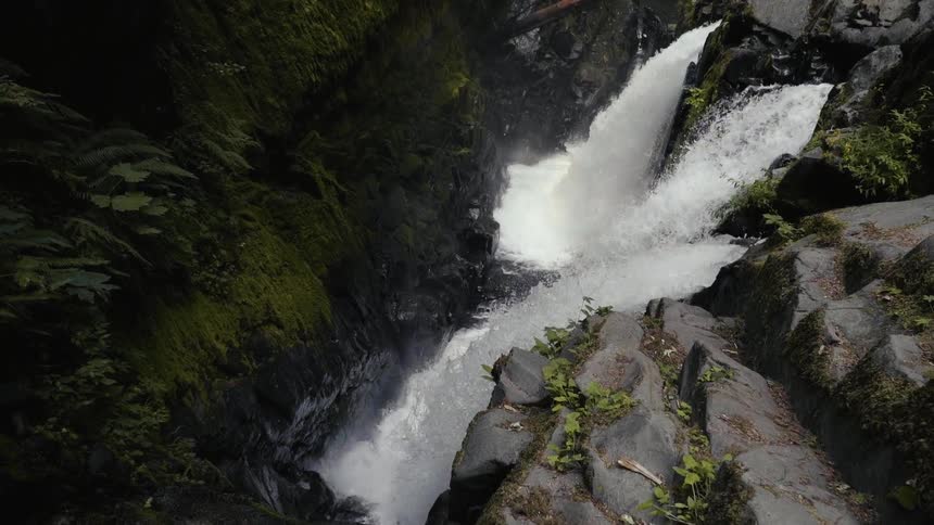 A waterfall is running down a cliff
