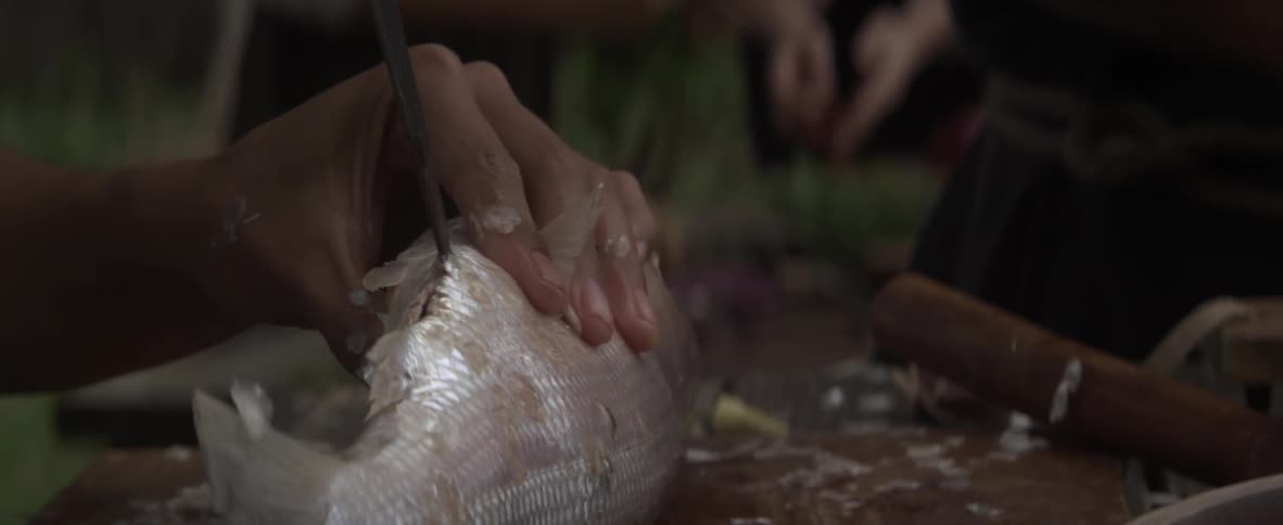 Person cutting into a fish