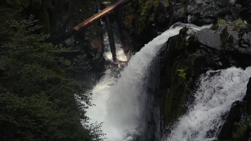 Waterfalls cascade into a ravine