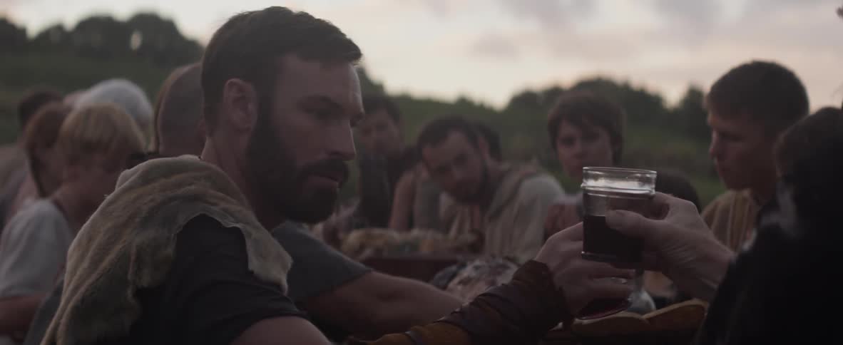 People sit together outside drinking and eating