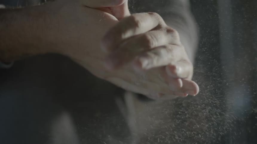 A person rolls dough in their hands