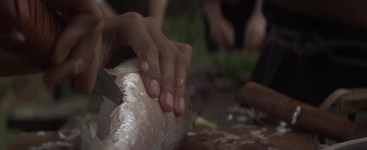 A man is filleting a fish