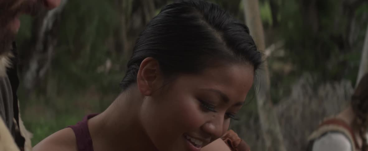 Bearded man laughs while talking with a woman