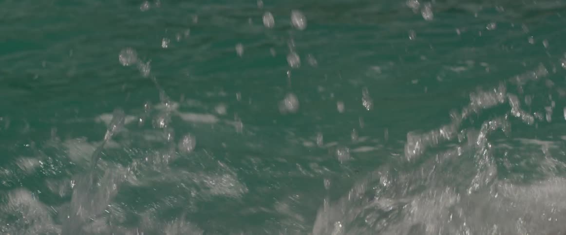 A person is rowing in the water with an ore