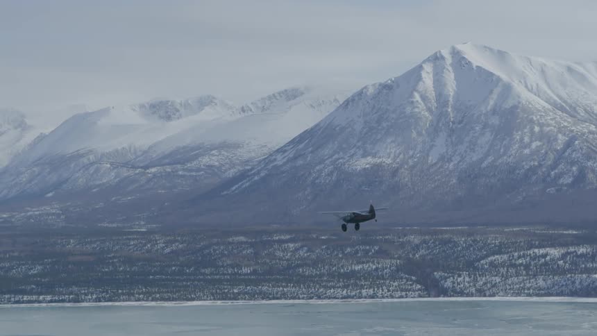 A helicopter is flying through an arctic area