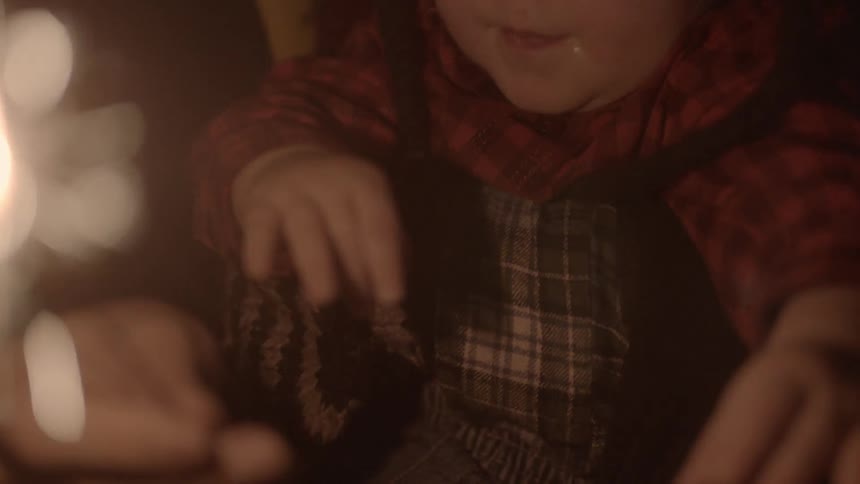 A baby holding a sparkler