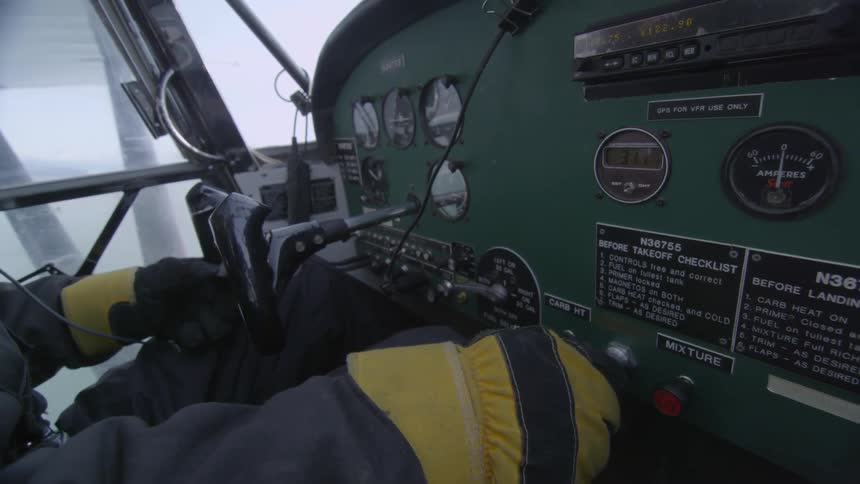 Person adjusting knobs on a dashboard