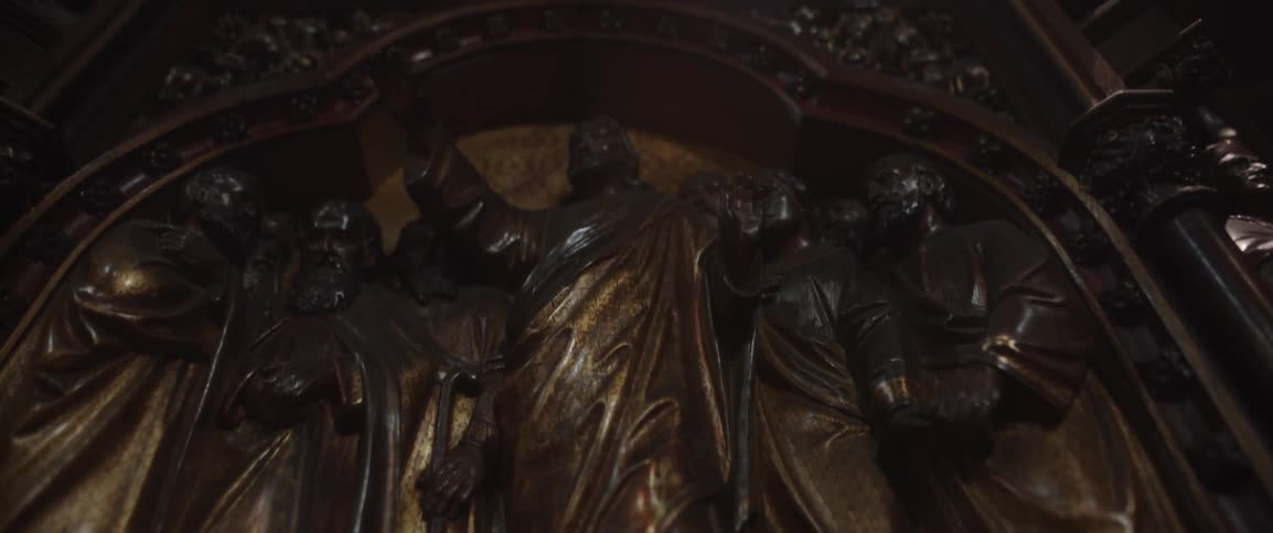 A bronze statue covers a wall