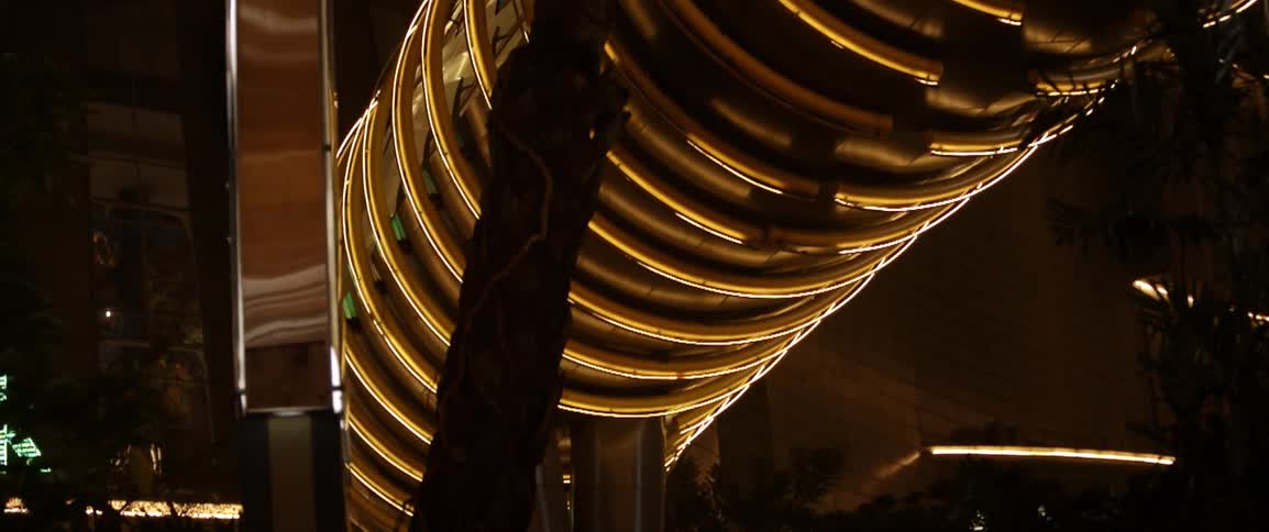 Large lighted tube outside being elevated at night