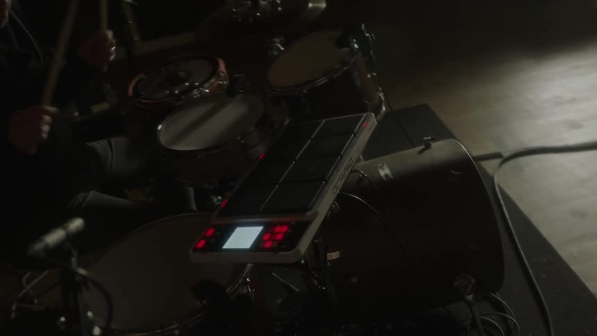 A man plays the drums in a studio