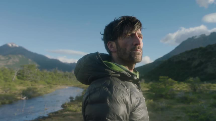A man looks around a valley
