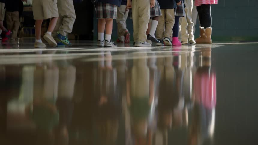 School children walks across the floor
