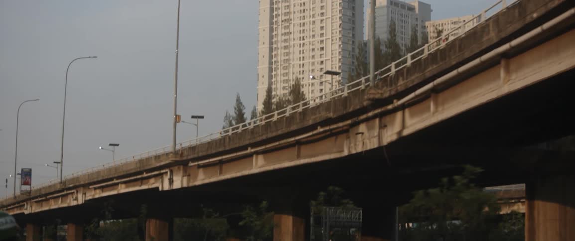 The overpass has large buildings behind