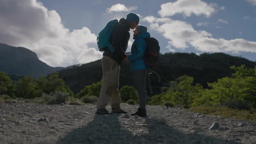 A person kisses another on the forehead