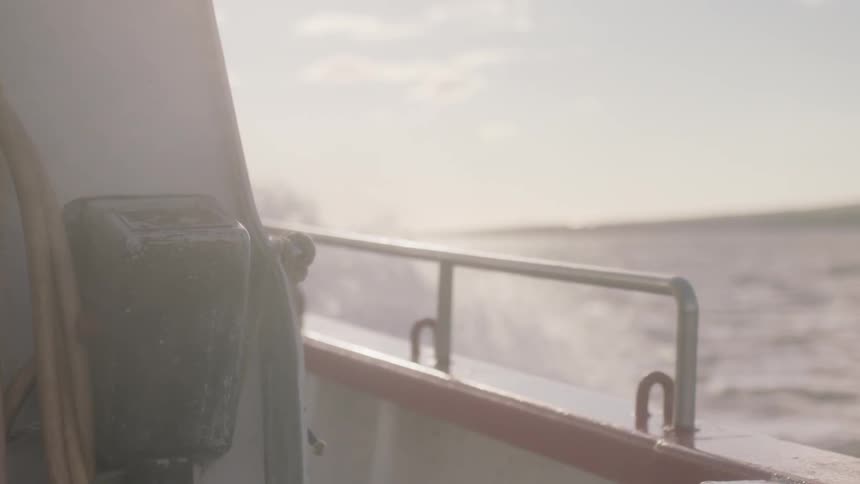 A boat travels through waves on the water