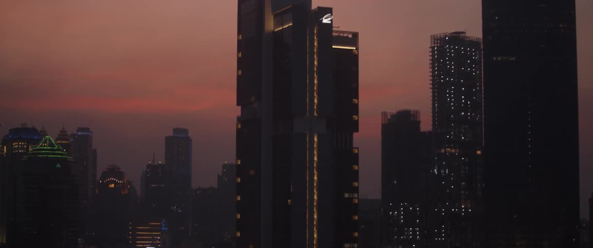 Skyscrapers with lights on at sunset