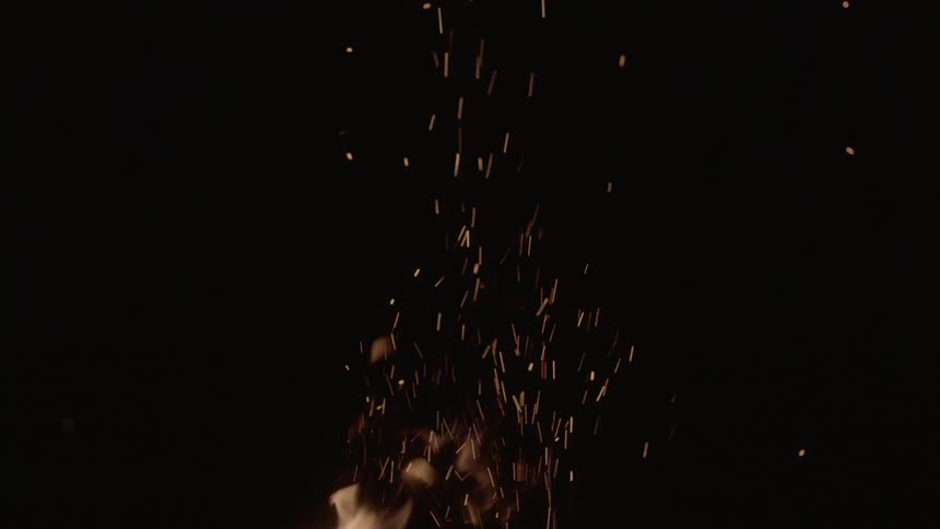 A flame burns in the night