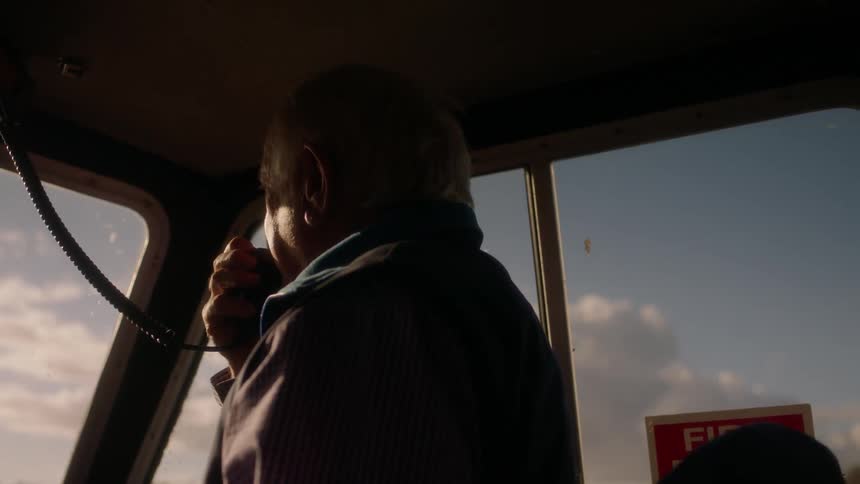 Man talks into an intercom in a vehicle