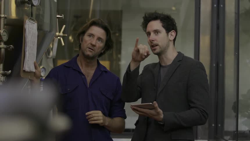 Two men are discussing something in a business setting