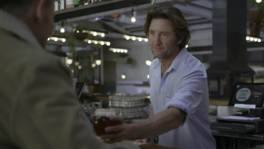 A bartender serves up a drink