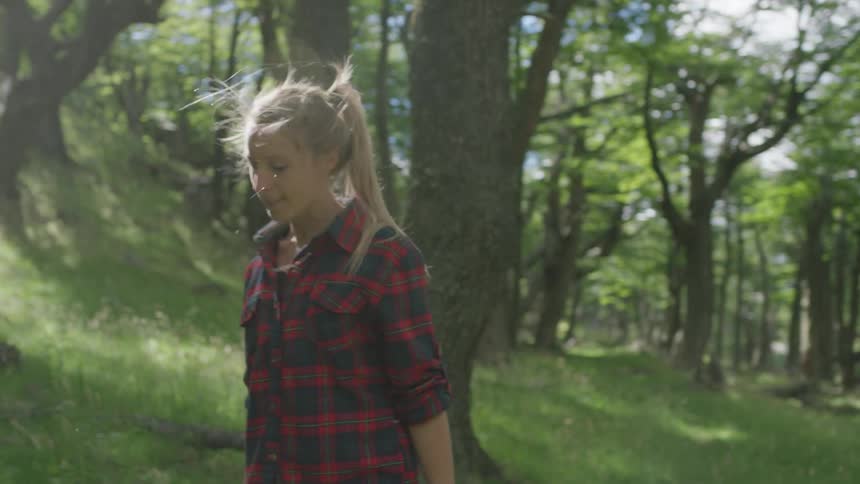 A woman is walking in the woods hiking