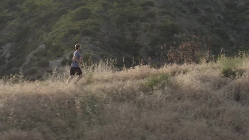 A man is jogging on the tall mountain
