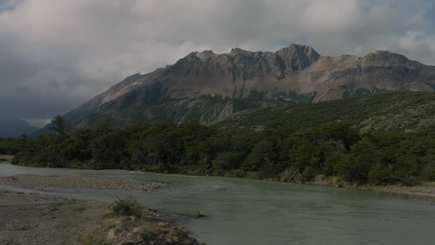 River flows gently under a cloudy sky