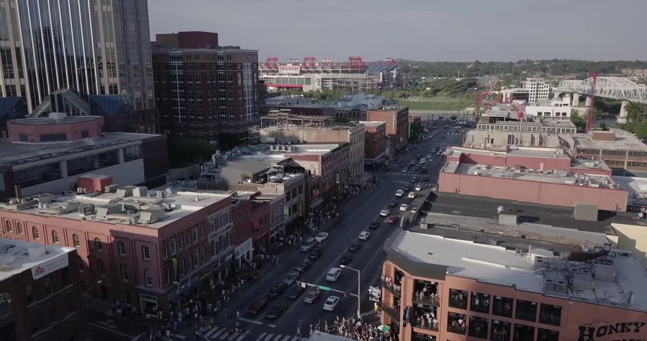 Groups of people cross a city street