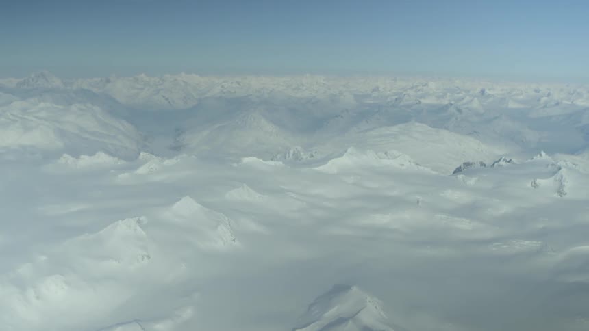 Aerial view of mountain peaks heavily blanketed in snow