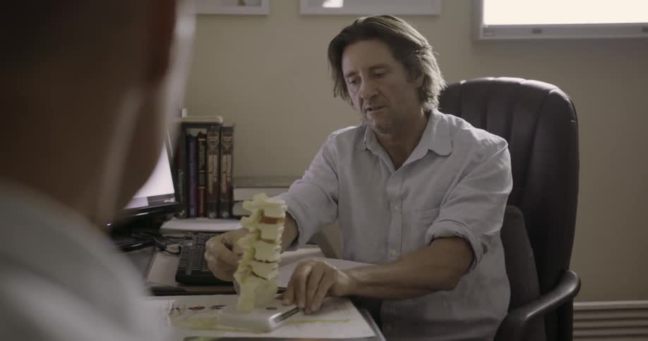 A man shows a co-worker a diagram