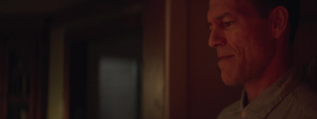 A man walks into a room and smiles
