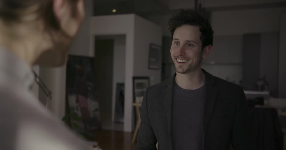 Two men are talking inside a building