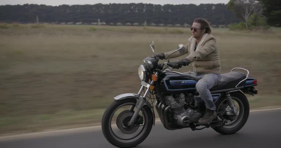 A man rides a motorcycle