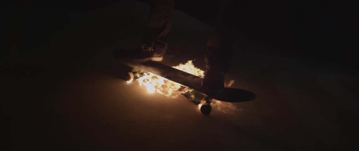 Someone rides on a burning skateboard