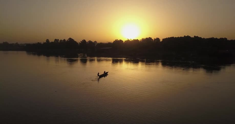 Two people kayaking at sunset