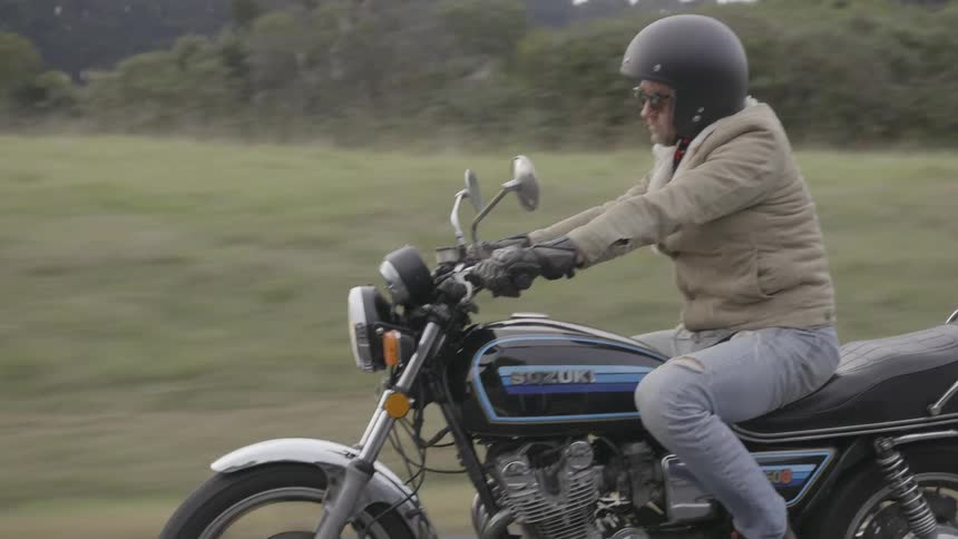 A man is riding his motorcycle