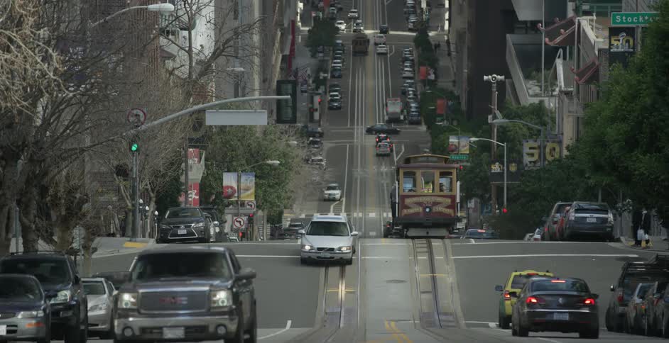 A train travels through the busy street
