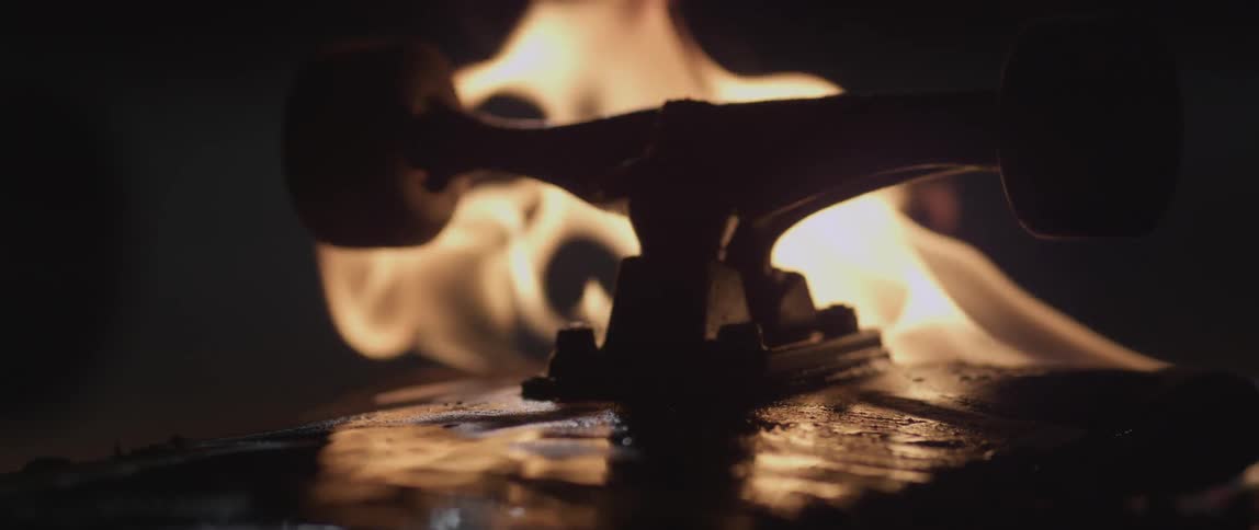 A skateboard burns outside at night