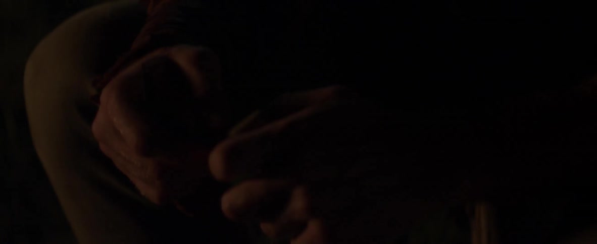 A man is looking down holding something in his hands