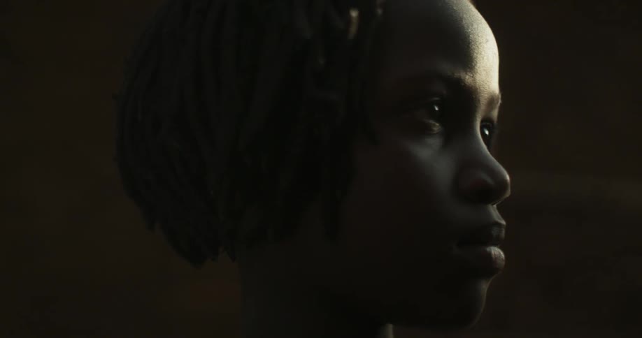 A child turns looking in a dark room