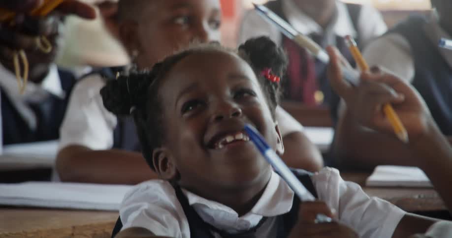 Pencils are handed out in a classroom