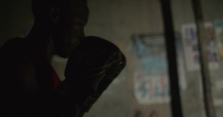 A boxer spars while wearing boxing gloves