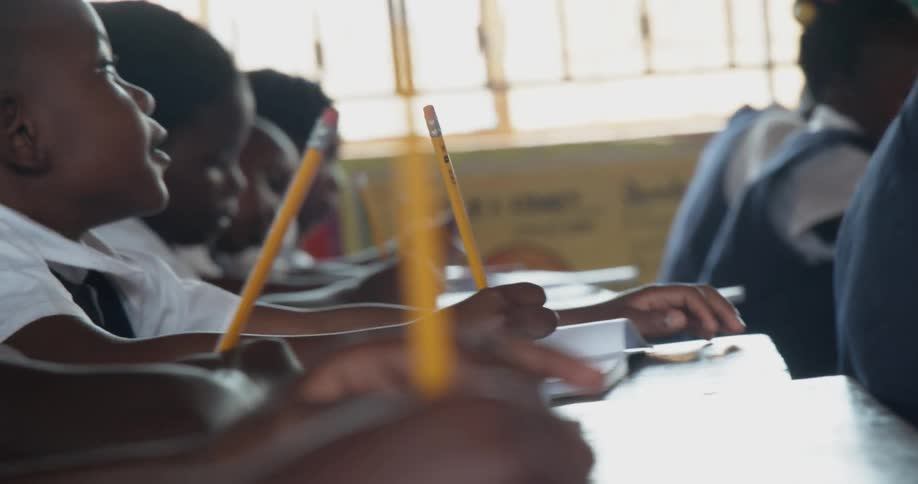 Children write with pencils in class