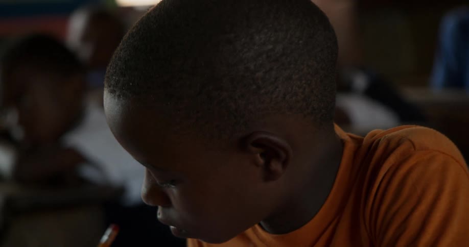 A child is learning writing in a classroom