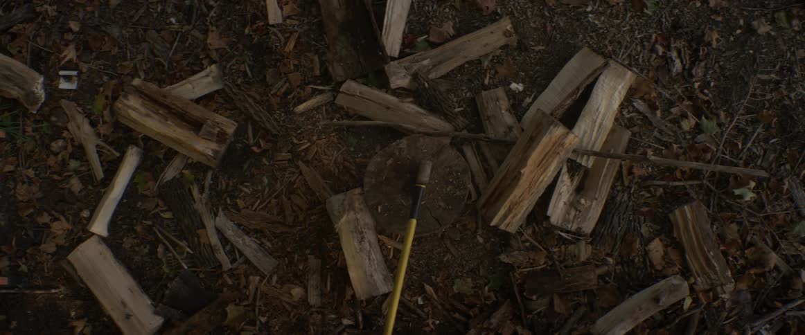 Wood is being split with an axe
