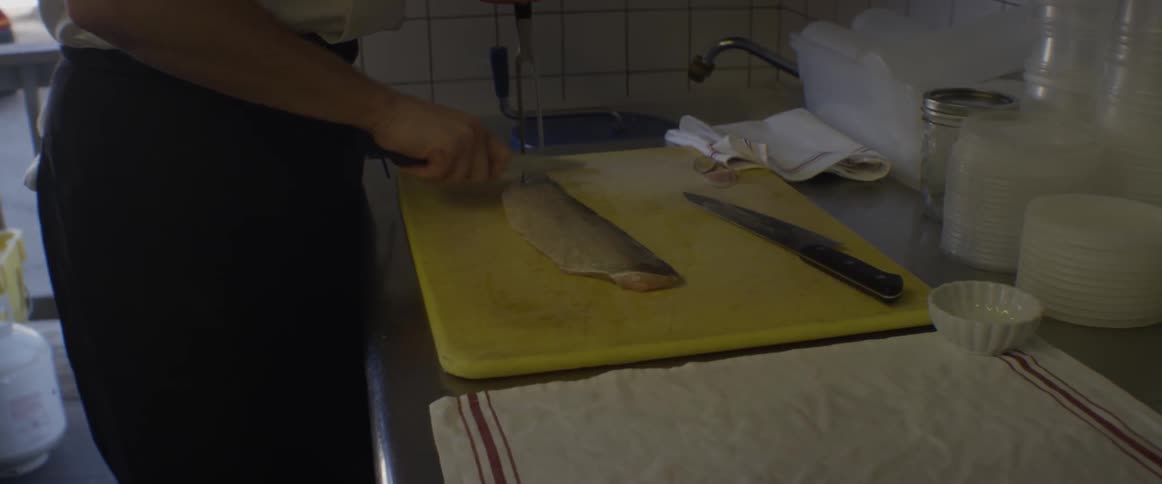 A man descales a fish